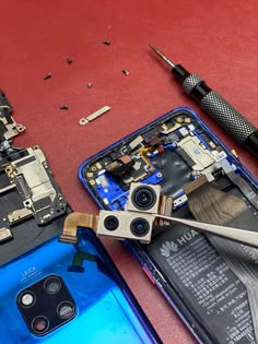 the tools are being used to repair an iphone's motherboard and rear camera