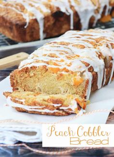 a loaf of peach cobbler bread with icing on top and sliced in half