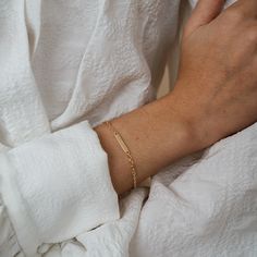 This bracelet is a great way to wear your heart on your sleeve— a beautiful string of gold that's tiny and delicate yet perfect for daily wear. The nameplate comes with hand engraving on either side, making each piece uniquely your own. A name and date, a special word or mantra, or the coordinate of somewhere special— whatever your heart desires, here's a good place to put it. 14k yellow gold (alternative metals available by request) Hand engraving included on front and back All engraving is don The Wallflower, Nameplate Bracelet, Heart On Your Sleeve, Alternative Metal, Special Words, Name Bracelet, Hearts Desire, Heart On, Diamond Sizes