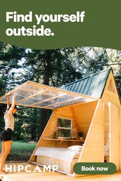 a woman standing on top of a wooden platform in front of a tent with the words, find yourself outside