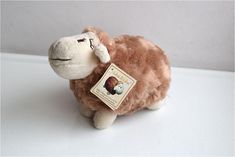 a stuffed animal with a tag on it's ear sitting on a white surface