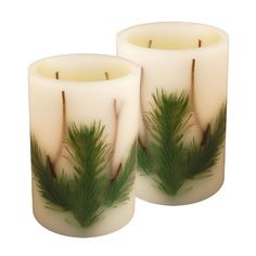 two white candles with green leaves on them