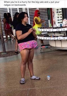 a woman standing in front of a table with cupcakes and a chicken on it