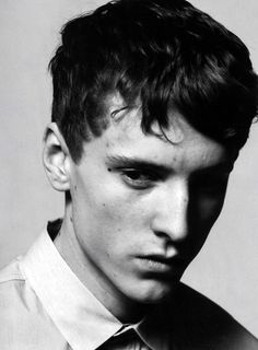 black and white photograph of a young man wearing a shirt and tie