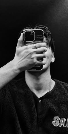 a baseball player holding up his cell phone to take a photo