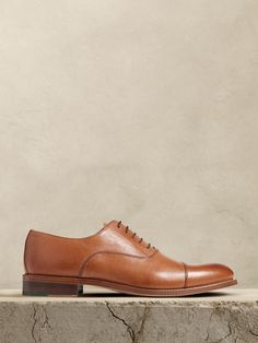 The perfect dress shoe, these timeless leather oxfords have a subtle, cap-toe construction, beautifully crafted for us in Portugal of exceptional, timeless leather.  Leather uppers.  Waxed laces.  Leather soles.  Made in Portugal.  Whole and half sizes. Trendy Hats, Brown Dress Shoes, Trendy Hat, Stylish Scarves, Groomsmen Attire, Shoe Inspo, Leather Dress Shoes, Cool Sunglasses, Dress Shoe