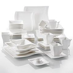 white dishes and cups are stacked on top of each other in the shape of a rectangle