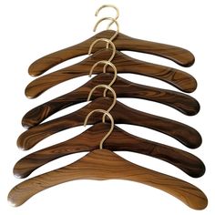 four wooden hangers with metal rings on them