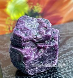 a purple rock sitting on top of a wooden table