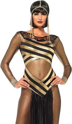 a woman in a gold and black costume with her hands on her hips, posing for the camera