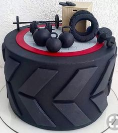 a cake that is decorated with black and red decorations