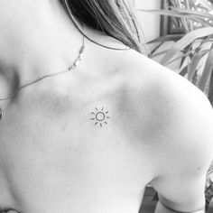 a woman with a small sun tattoo on her back