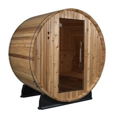 a wooden barrel sauna is shown with the door open