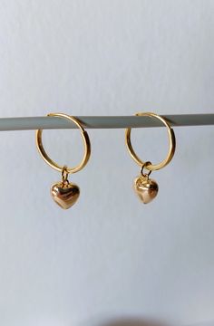 925 sterling silver gold plated hoop earrings, 14mm diameter, with an 18k gold plated heart. Length of the earring is 25 mm. The 18 carat gold filling is approx. 100 times thicker than with simple gold plating. The gold layer is mechanically bonded to the brass base material Goldfilled is resistant to abrasion under normal use. Small inclusions, color deviations and irregularities on the pearls or on the metals are part of the peculiarity of the materials. If you have special requests, want unusual pieces of jewelry, please feel free to contact me. More beautiful pieces of jewelry can be found here: https://www.etsy.com/de/shop/MerlesSchmuckArt Handmade Dainty Gold Huggie Earrings, Handmade Gold Dainty Huggie Earrings, Hoop Jewelry With Heart Charm For Anniversary, Small Hoop Earrings With Heart Charm For Anniversary, Small Hoop Jewelry With Heart Charm For Anniversary, Minimalist Hoop Earrings With Heart Charm For Anniversary, Gold Earrings With Heart Charm In 14k Gold Filled, Gold Sterling Silver Hoop Earrings For Gift, Gold Huggie Jewelry Gift For Her