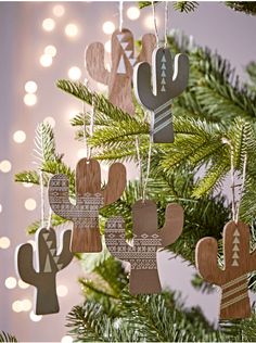 wooden cactus ornaments hanging from a christmas tree