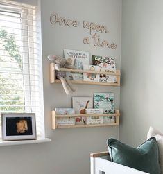 a baby's room with bookshelves and pictures on the wall above it