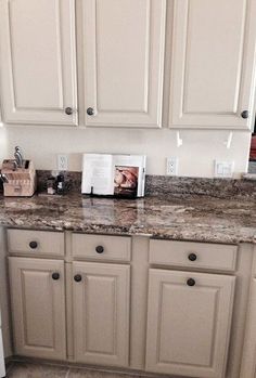 a white refrigerator freezer sitting inside of a kitchen next to a counter top oven