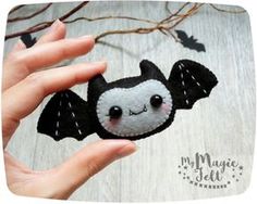 a hand holding a small felt bat