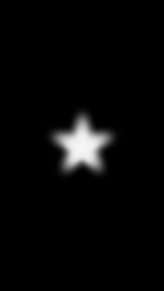 a black and white image of a star in the dark