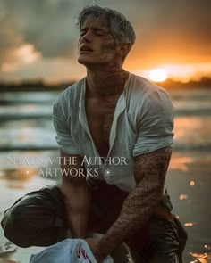 a man sitting in the water with tattoos on his arm and chest, looking up at the sky