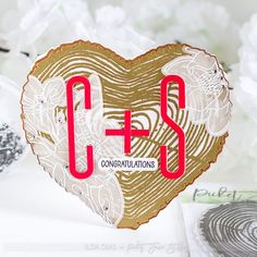 a heart shaped card with the word c + s in red and white on it