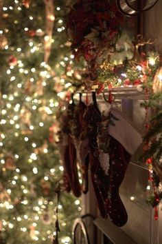 a christmas tree with stockings hanging from it