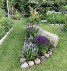 a garden with rocks and flowers in it