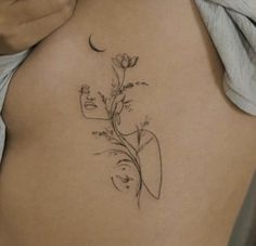 a woman's stomach with a flower tattoo on it