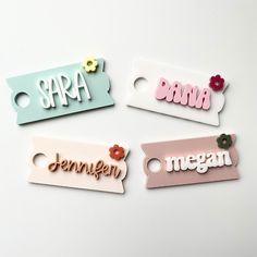 four name tags with flowers on them