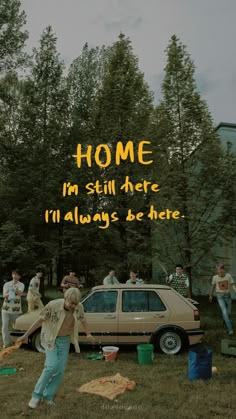 a group of people standing around a car with the words home in yellow on it