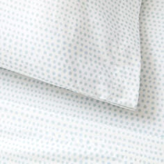 a close up view of a blue and white polka dot sheet set