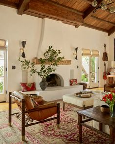 a living room filled with furniture and a fire place in the middle of a room