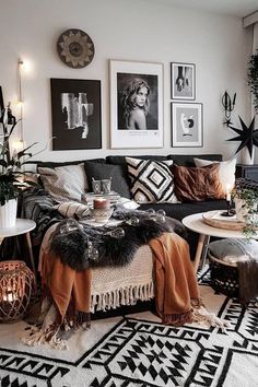 a black and white living room with pictures on the wall, coffee table and rug