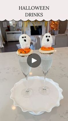 two glasses filled with halloween drinks sitting on top of a white plate next to each other