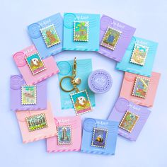 a bunch of stamps and a keychain sitting on top of each other in front of a blue background