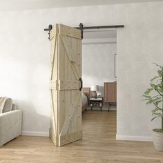 a living room with a white couch and wooden doors open to reveal a dining area