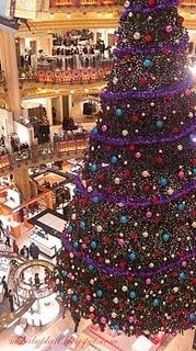 a large christmas tree in the middle of a mall