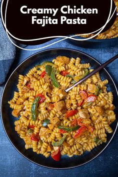 creamy chicken fajita pasta on a black plate with a white sign above it