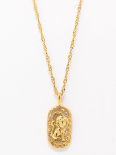 a gold necklace with an egyptian design on the front and back of it, hanging from a golden chain