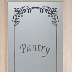 the word pantry is etched into a glass door with an ornate frame and border around it