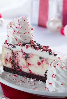 a piece of cake with white frosting and red sprinkles