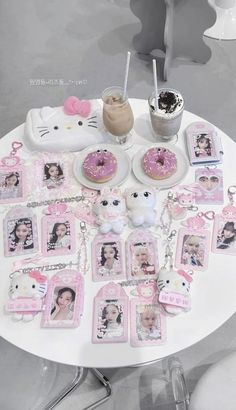 a table topped with lots of pink items and pictures next to a cup filled with coffee