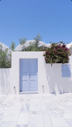 a white building with blue doors and windows