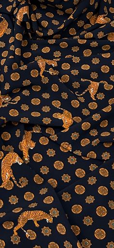 a black and gold patterned fabric with tigers on it