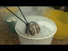 a bird sitting in a bucket with steam coming out of it