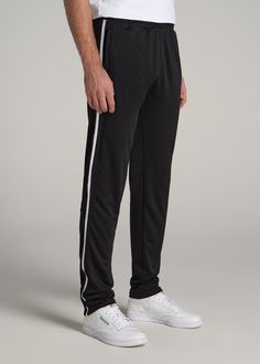 About Our Tall Men's Pants These men's tall athletic pants are a classic take on an athleisure essential. When it comes to athleisure, a good fit is key. You need something that's comfortable enough to relax in yet capable enough to work out in – but as a tall guy, it can be hard to find options that work for your height. You either have to compromise on a baggy fit or settle for lengths that are way too short. Not anymore. We know how hard it is to find quality styles when you're tall, which is Black Sportswear Joggers With Side Pockets, Sporty Straight Leg Sweatpants With Side Stripes, Casual Training Bottoms With Side Pockets, Black Athleisure Pants With Straight Hem, Casual Training Bottoms For Sports Season, Sports Joggers With Side Pockets, Sports Full-length Joggers With Side Pockets, Black Sweatpants With Elastic Waistband For Jogging, Full-length Sports Joggers With Side Pockets