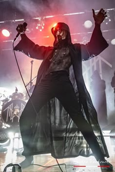 a man dressed in black performing on stage