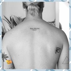 a woman with a tattoo on her back and palm tree behind her head, in black and white