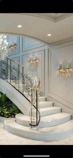 an elegant staircase with chandelier and marble steps