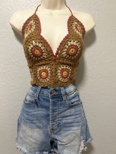 a mannequin wearing shorts and a crochet top